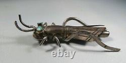 Sterling silver Navajo grasshopper broach stamped with blue turquoise eyes